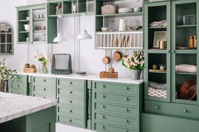 kitchen with green painted cabinets