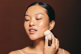 woman applying bronzer