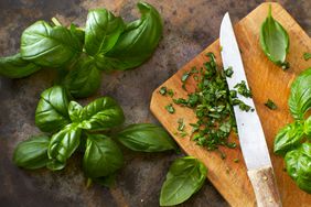 Chopped and whole basil on a cutting board