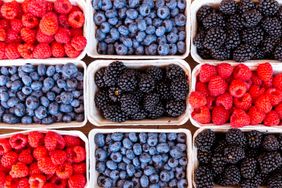 Raspberries, blackberries, and blueberries in containers