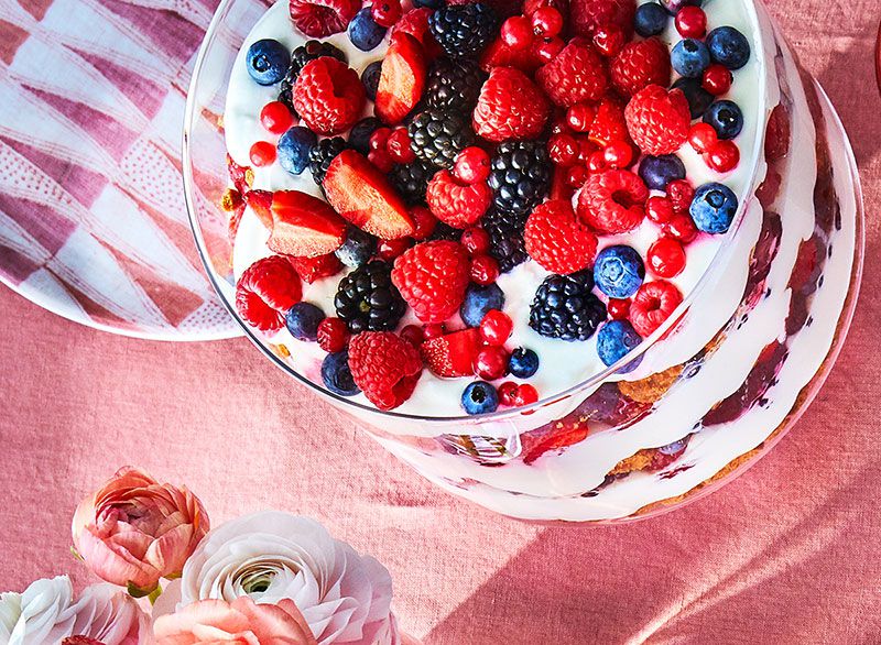 In this berry trifle, elderflower-spiked whipped cream draws out the layers of fresh summer berries, and crushed cookies soak up the berry juices.