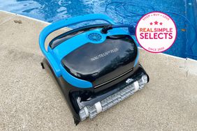 Dolphin Nautilus CC Plus Robotic Pool Cleaner outdoors on the edge of a pool