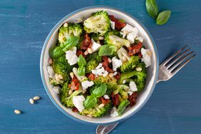 healthy broccoli salad with feta cheese sun dried tomatoes pine nuts.. vegetarian low carb keto diet