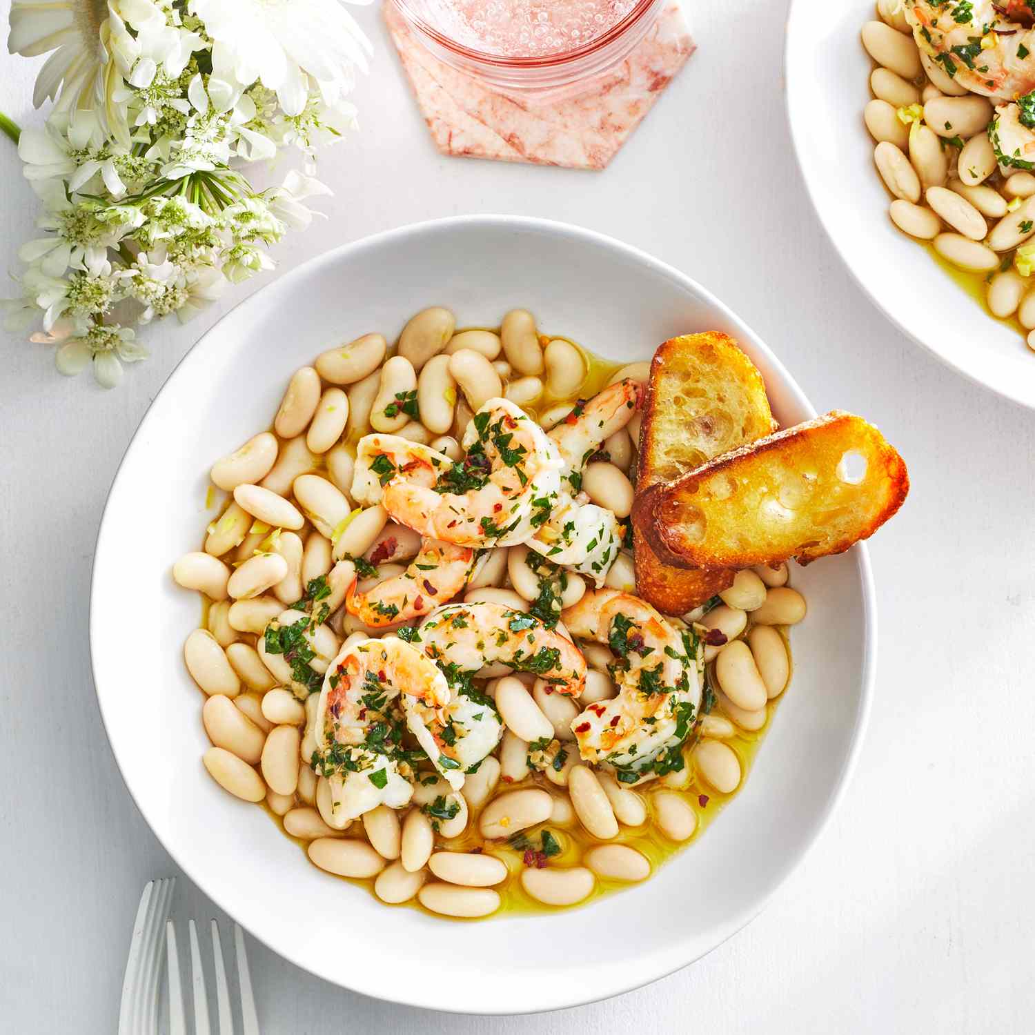 Overhead View of Buttery Shrimp With Marinated White Beans Served in White Bowl