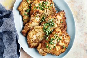 Schnitzel on a plate on multicolored background