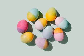 Many different colored eggs on pastel blue background. Easter minimal concept. Flat lay, top view