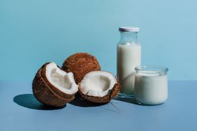 coconuts with milk and cream on a blue background