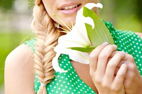 woman holding flower with fishtail braid