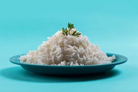 Cooked plain white basmati rice with corriander in a blue plate