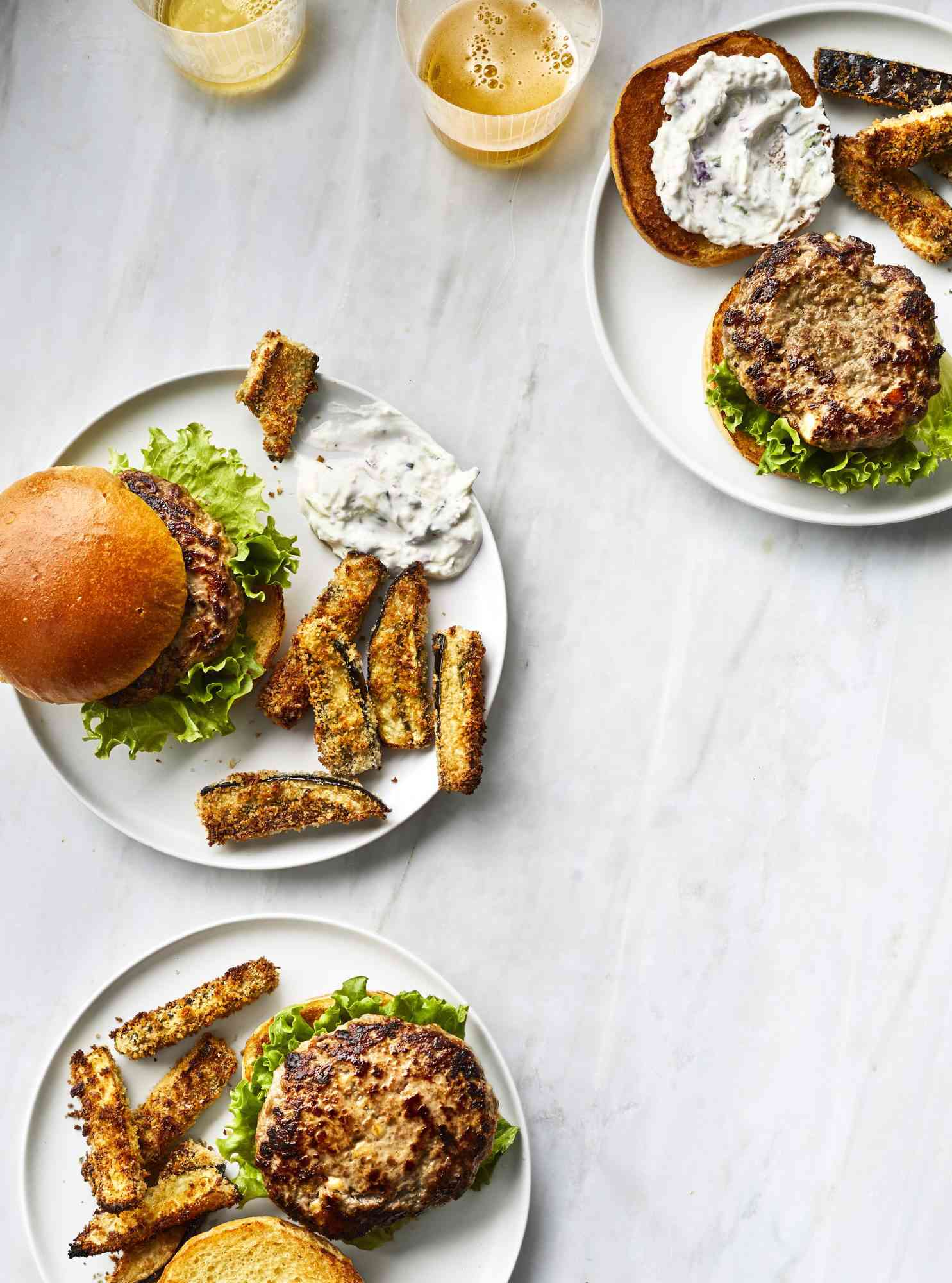 Greek Lamb Burgers With Baked Eggplant Fries, Served on Two White Plates, One Open Face