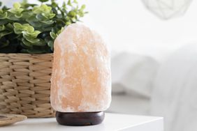 What Do Salt Lamps Do, and Do They Have Health Benefits? Here's What the Research Says: salt lamp on table