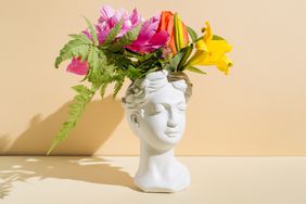 Flowers coming out of a head sculpture