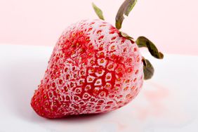 Bright Red Frozen Strawberry on white background