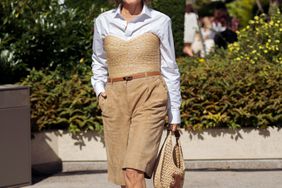 Renia Jaz wears brown shorts, white shirt, straw strapless top or corset and beige bag outside the Lovechild 1979 show during day two of the Copenhagen Fashion Week (CPHFW) SS25 