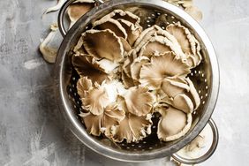 Fresh raw oyster mushrooms in a colander