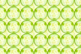 Close up of fresh cucumber slices (a hydrating food) arranged in rows