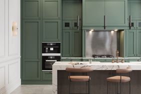 image of modern kitchen interior with green wall. Luxurious kitchen interior with high chairs at the kitchen counter