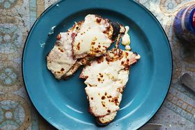 Open Faced Croque Monsieur with leftover ham served on a blue circular plate