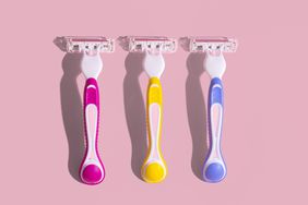 Three razors on a pink background