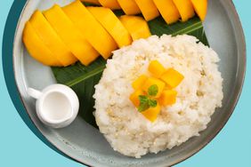 Delicious Thai mango sticky rice with cut fresh mango fruit in a plate on gray table background.