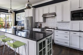 The nice modern kitchen with a partial view of the seating area