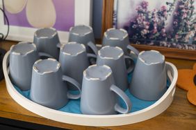 Close-Up Of Upside Down Gray Cups On Tray 