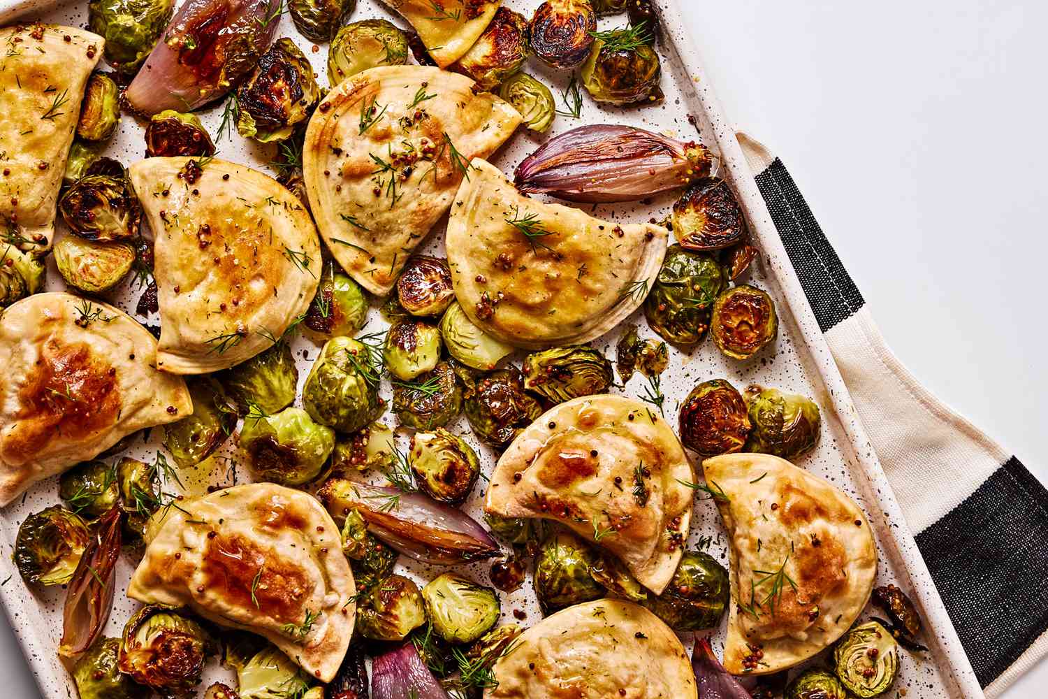 Sheet Pan Pierogies With Roasted Brussels Sprouts, Shallots, And Mustard Dressing