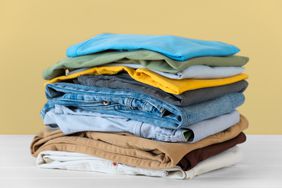 Stack of old clothes folded on countertop 