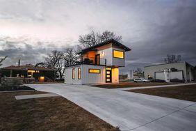 tiny house on street with other homes