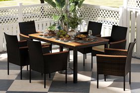 The Red Barrel Studio Kristain Six-Person Rectangular Outdoor Dining Set outside on a patio