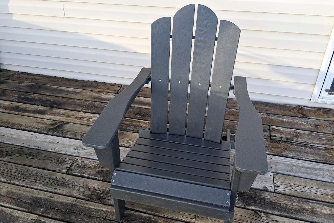 The KINGYES Folding Adirondack Chair on a deck