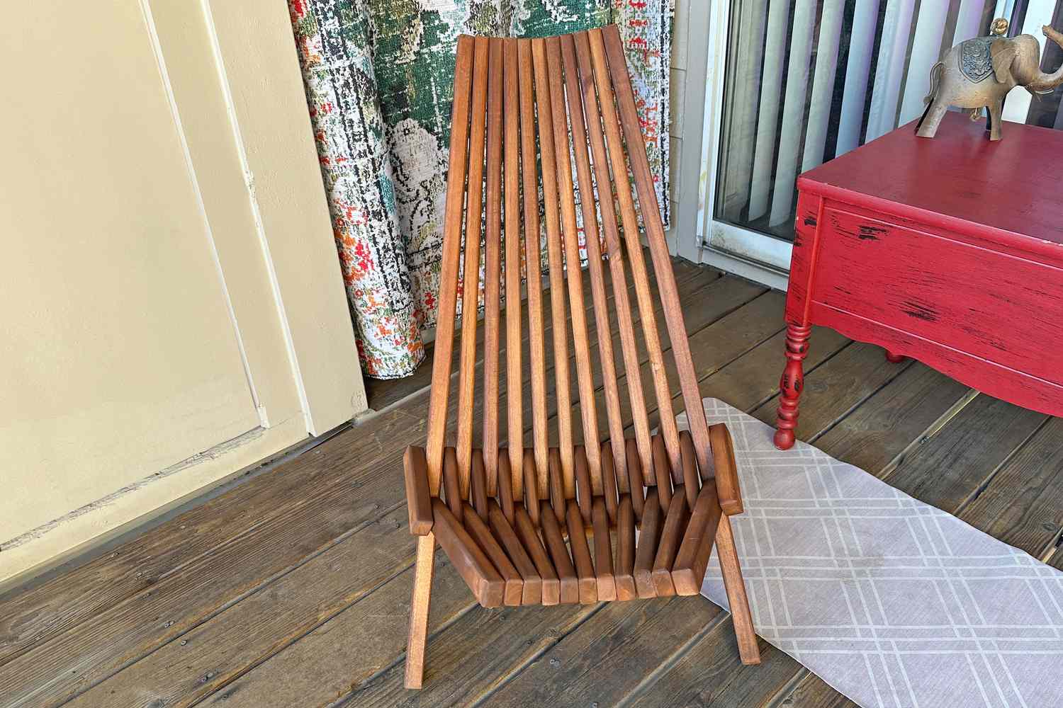 The Sand and Stable Abingdon Wood Folding Adirondack Chair in a sun room