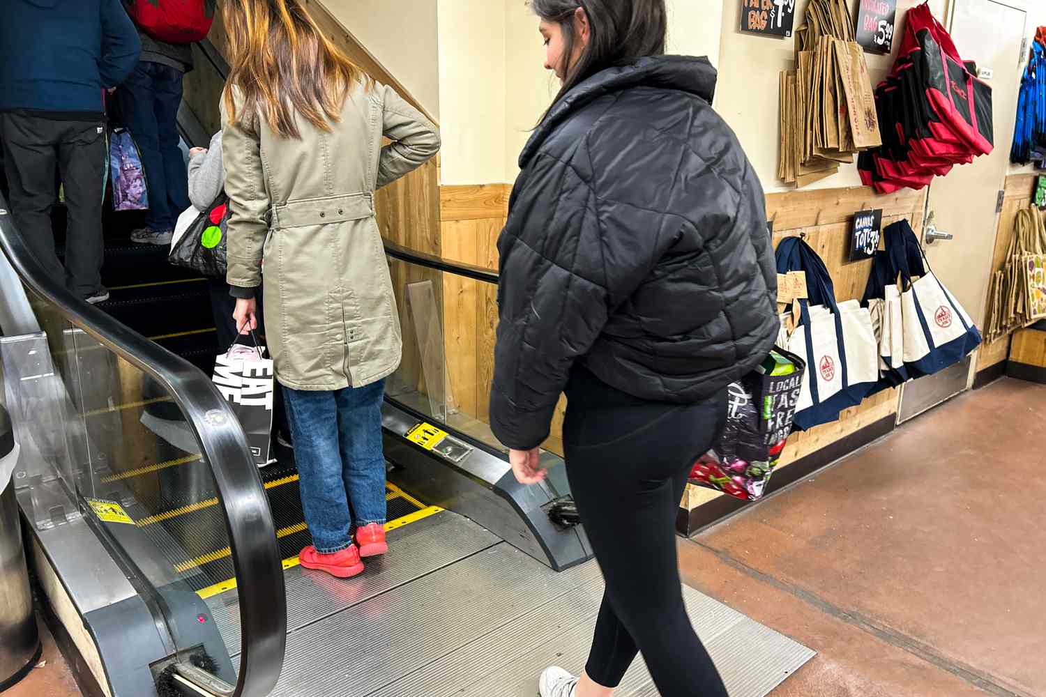 A person walks around a store while wearing the Spanx Booty Boost Active 7/8 Leggings