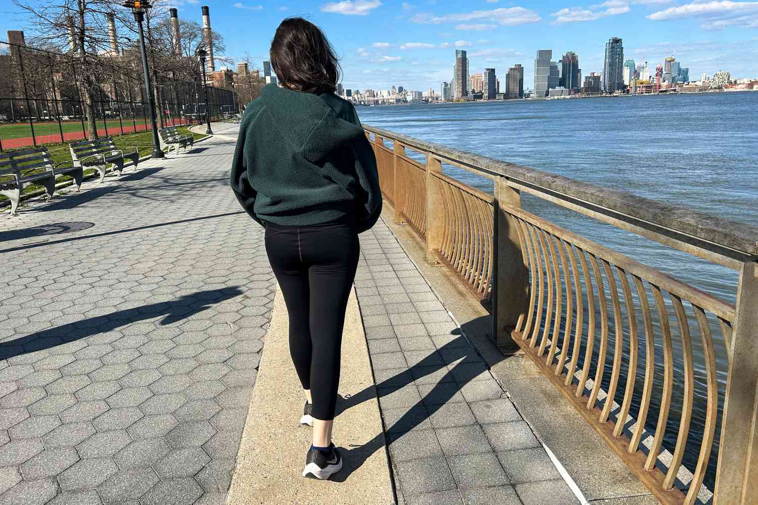 A person walks outside while wearing the Spanx Booty Boost Active 7/8 Leggings