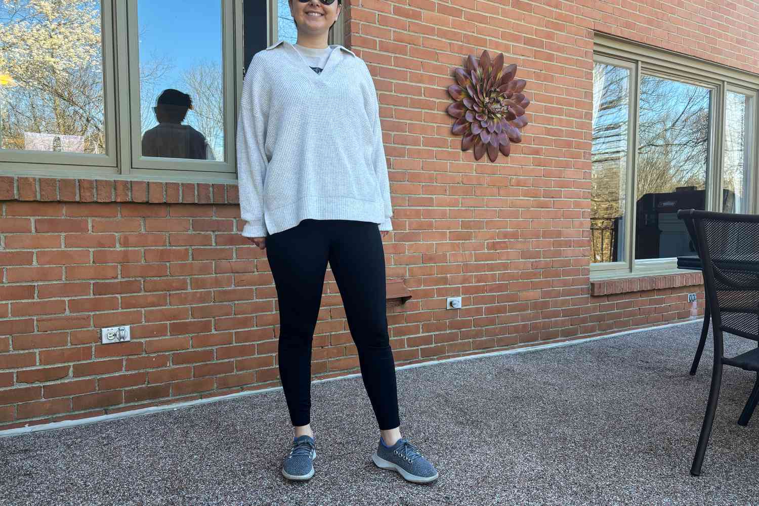 A person stands outside while wearing the Vuori Stride Legging