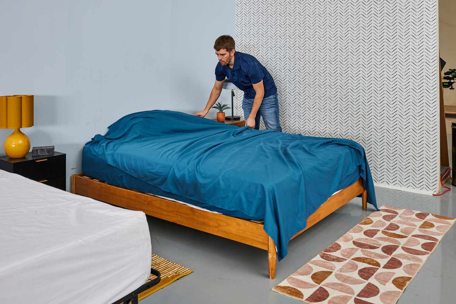 A person tucking into a mattress the Comfort Spaces Coolmax Moisture Wicking Sheet Set