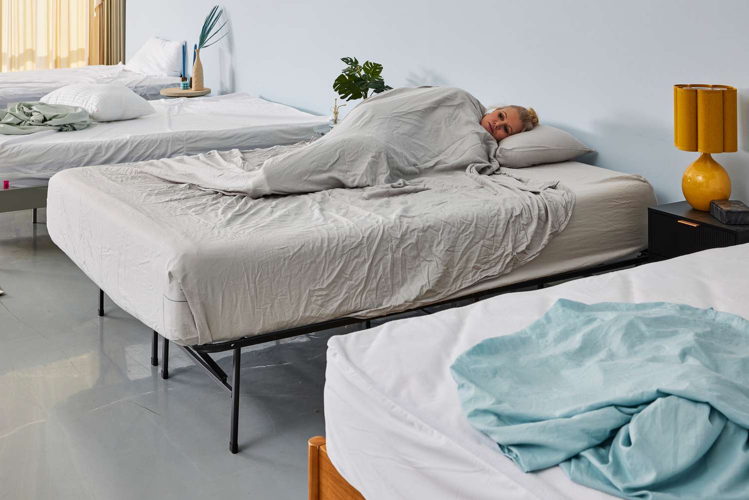 A person covered in the Quince Linen Bamboo Sheet Set