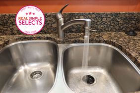 A kitchen faucet turned on letting water run into a sink with a Real Simple Selects badge.