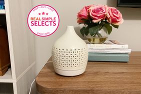 The Opalhouse Cutout Ceramic Oil Diffuser on a wooden table