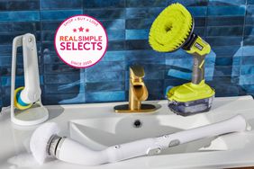 Three electric scrubbers placed on a sink with blue backsplash