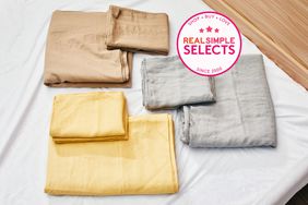 various sheet sets folded on bed