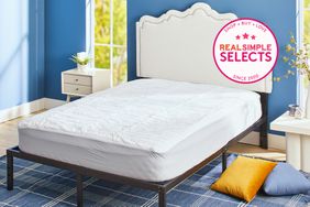 The Better Homes & Gardens Waterproof Cotton Mattress Pad on top of a bed