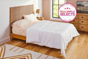 The Riley Down Alternative Comforter on a bed in a bedroom setting