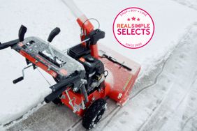 Ariens Snow Blower blowing snow from pavement