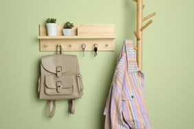 Wooden hanger for keys on light green wall