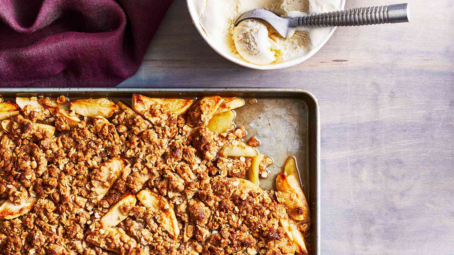 Sheet Pan Apple Crisp With a Bowl of Vanilla Ice Cream on the side