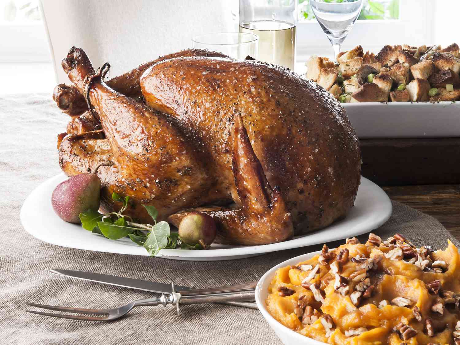 Stuffing, sweet potatoes and smoked turkey on wooden table