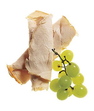 Sliced turkey with green grapes