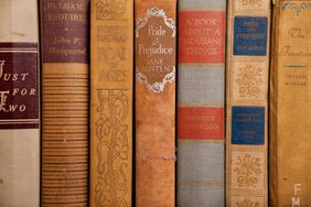 A stack of worn, old classic books