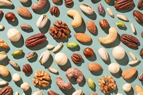 Mixed Nuts Include Almonds, Brazil Nuts, Cashews, Hazelnuts, Macadamia Nuts, Pecans, Pine Nuts, Pistachios, Walnuts Flat Lay Green Background Directly Above View.